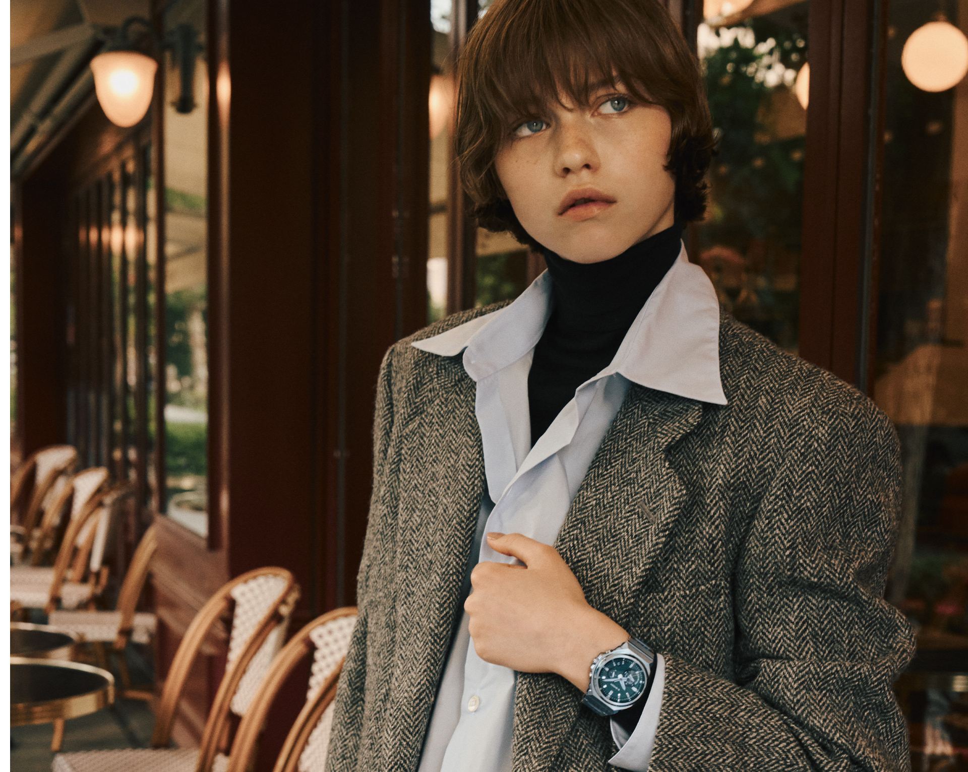 A model wearing the GST-B1000D-3A standing on a terrace.